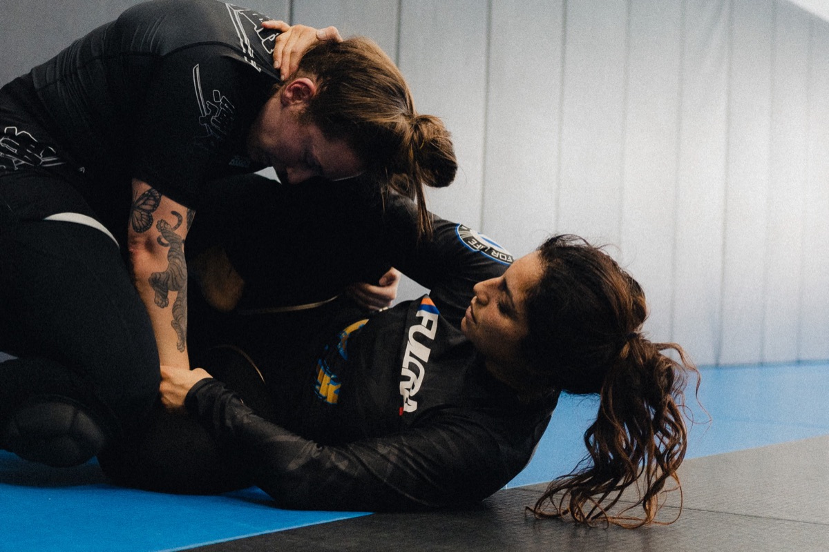 Coach demonstrating BJJ technique